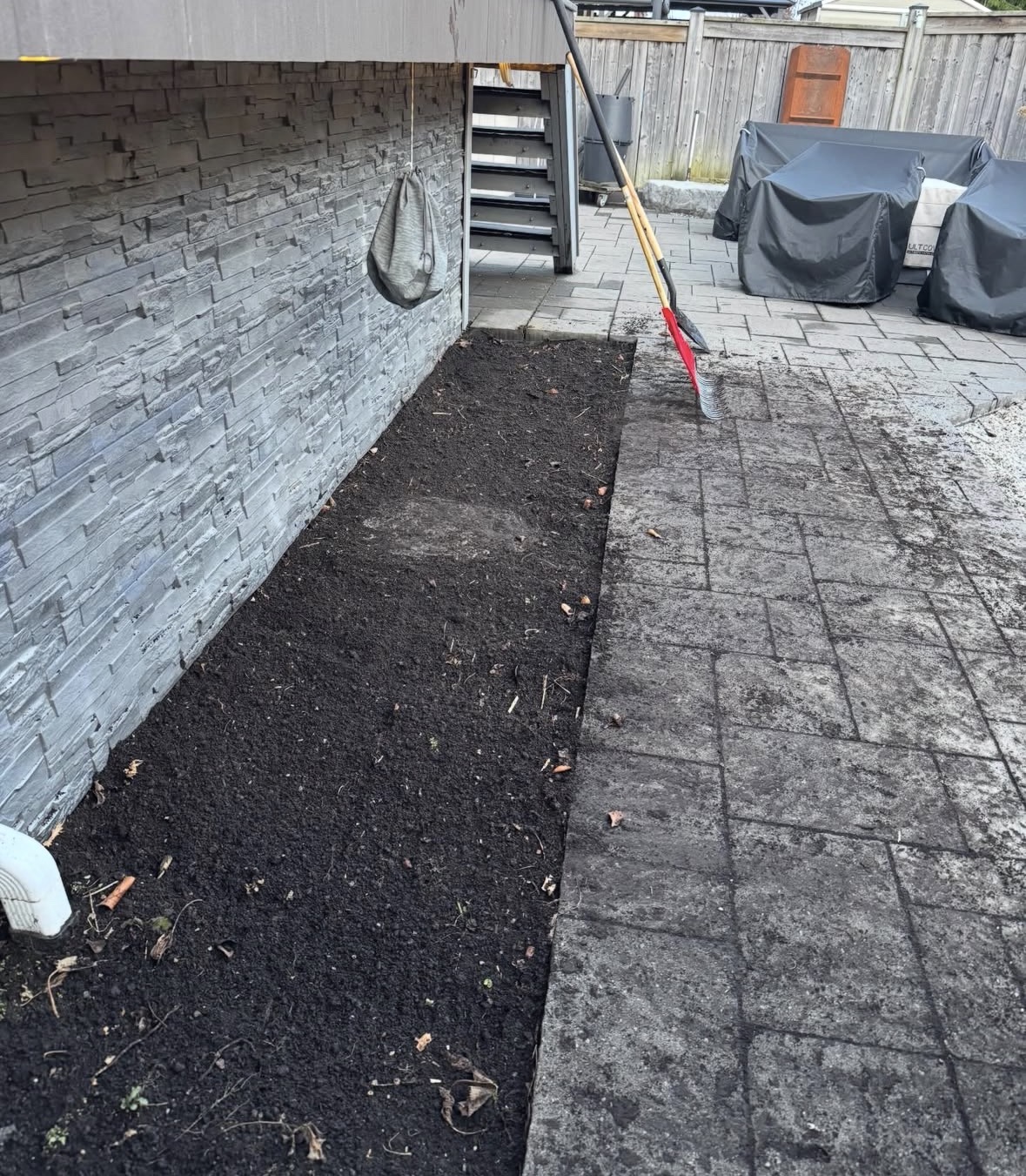 After view of backyard garden bed and patio area