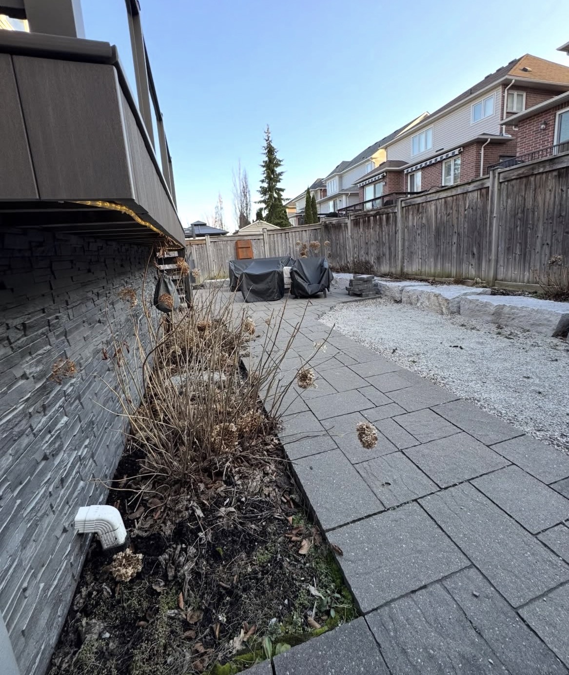 Before view of stone patio and landscaping area